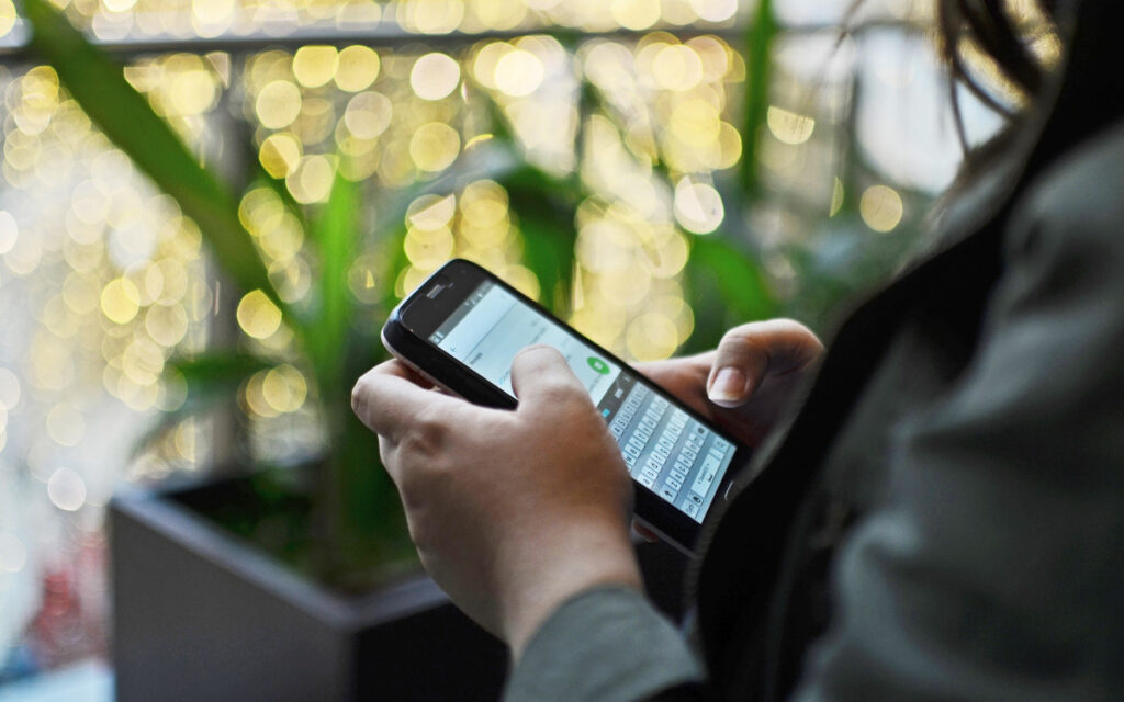 Person using good cybersecurity habits on phone