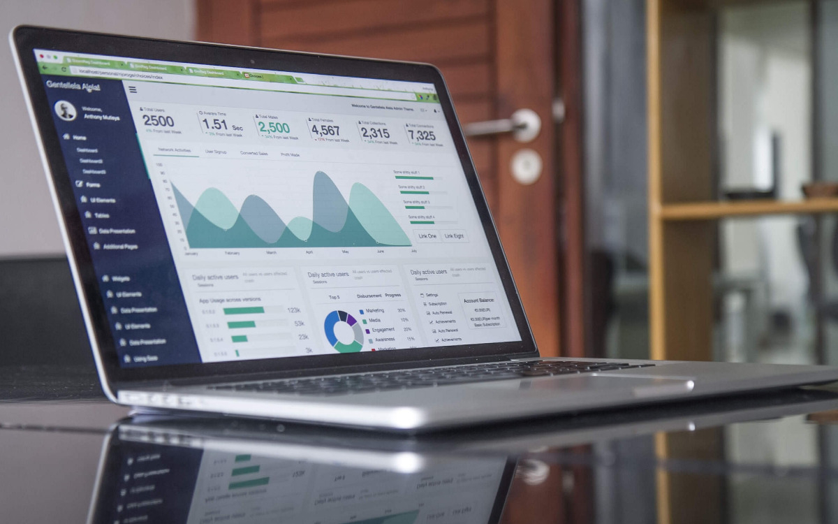 Laptop showing nonprofit IT services data on a reflective desk.