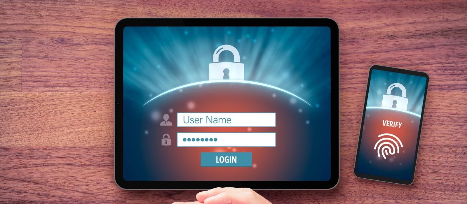 A tablet and a phone on a table being used to log into an account using multi-factor authentication (MFA).