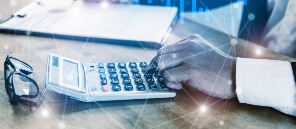 I hand on a calculator estimating IT costs.