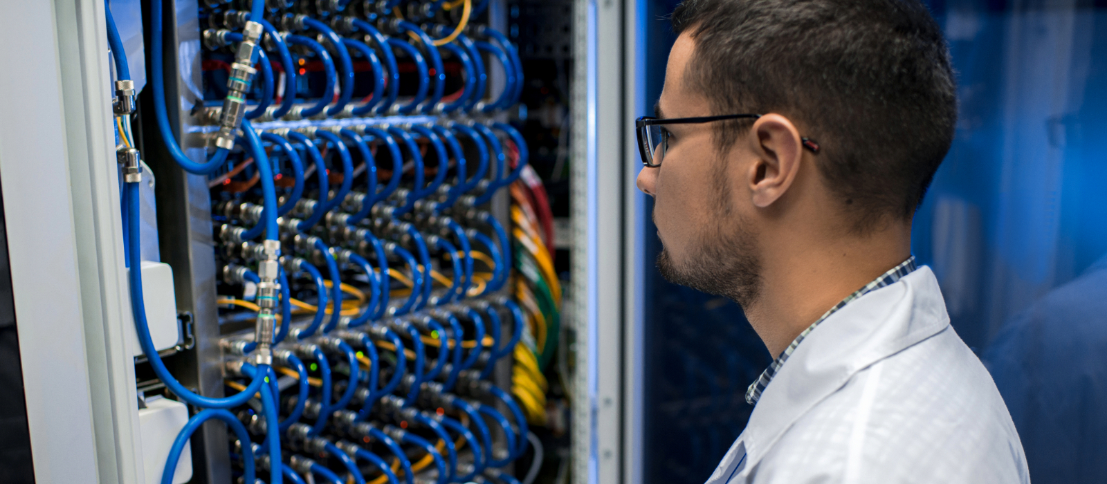 IT technician inspecting server cables as part of fully managed IT support services.