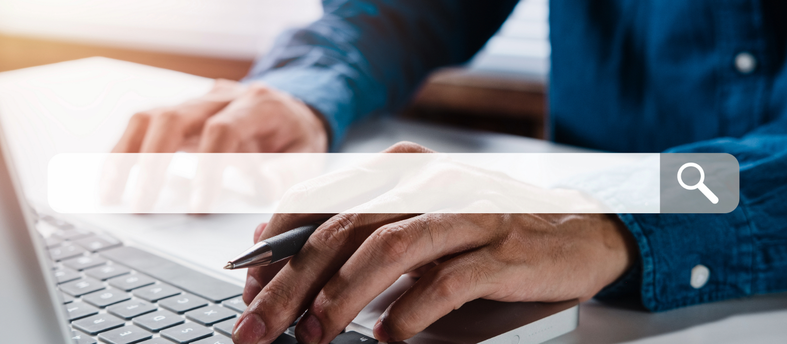 Person typing on a laptop with a search bar overlay, representing someone searching for information through a web browser.