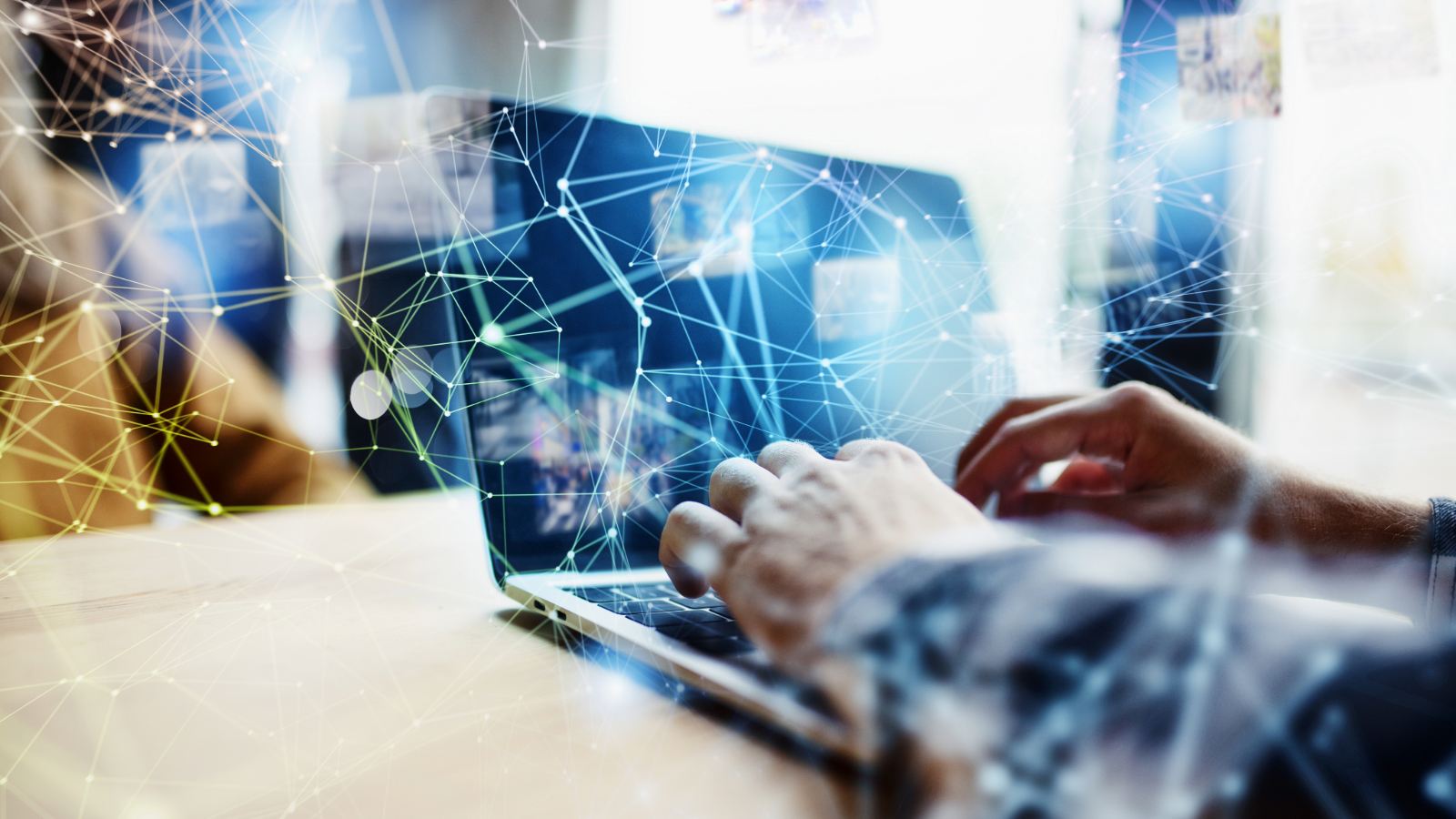 Person working on a laptop with abstract digital network lines overlayed, representing internet failover and continuous connectivity.