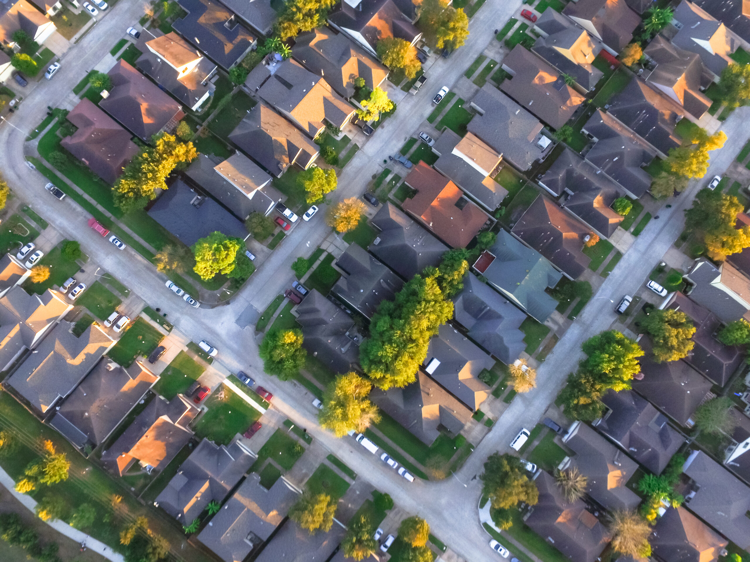 Aerial view of a suburban neighborhood representing housing voucher management, compliance challenges, and community support.