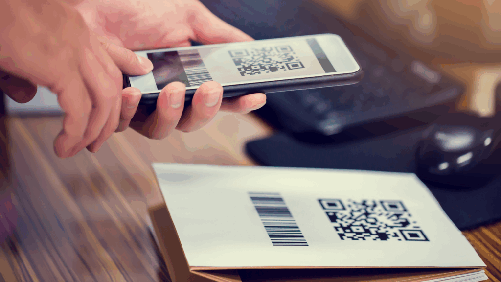 Person scanning a QR code with a smartphone, representing the risk of quishing attacks that use malicious QR codes.