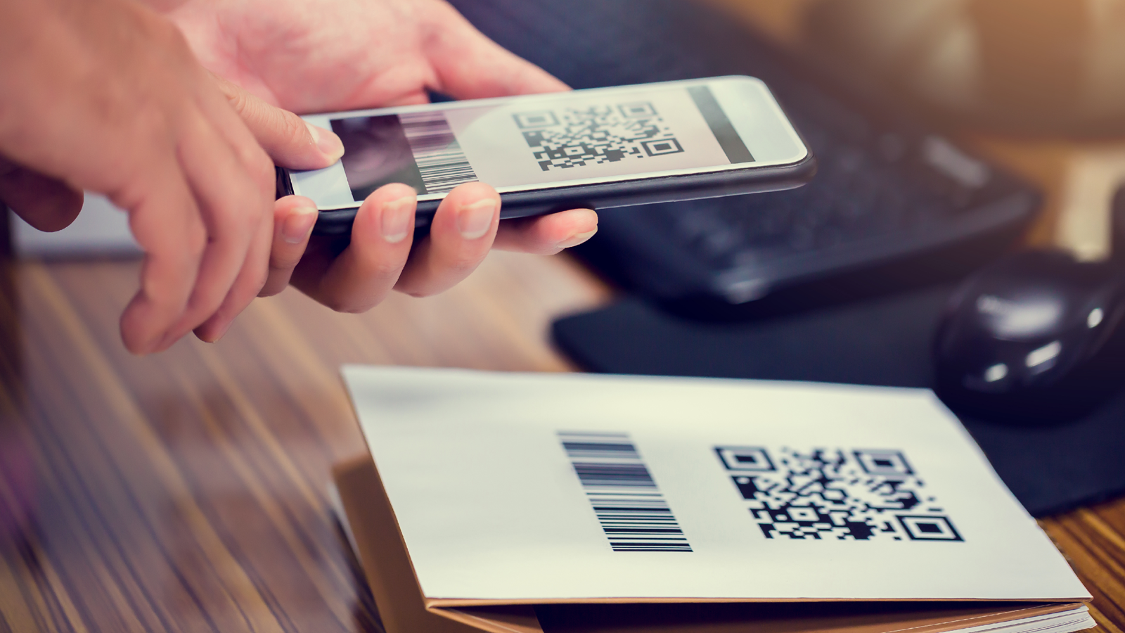 Person scanning a QR code with a smartphone, representing the risk of quishing attacks that use malicious QR codes.